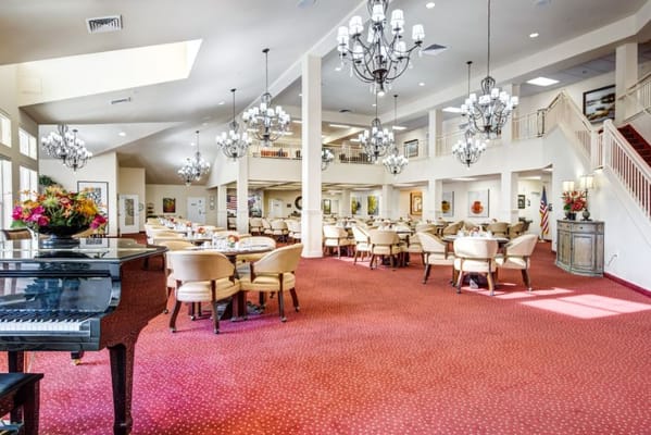 Spacious dining area with chandeliers and floral arrangements