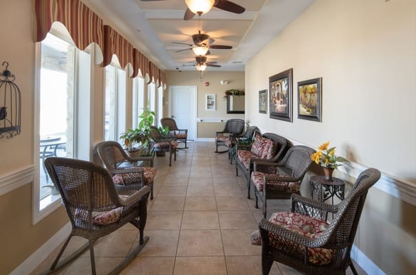 Spacious corridor with seating and decor in a senior living facility