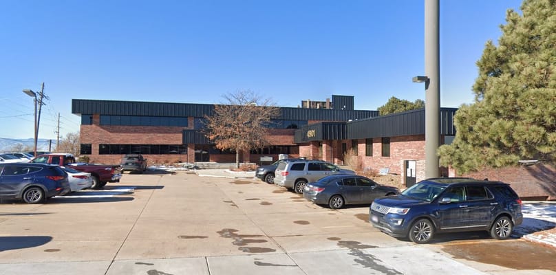 Exterior of iCare Home Health Care Agency building with parked cars