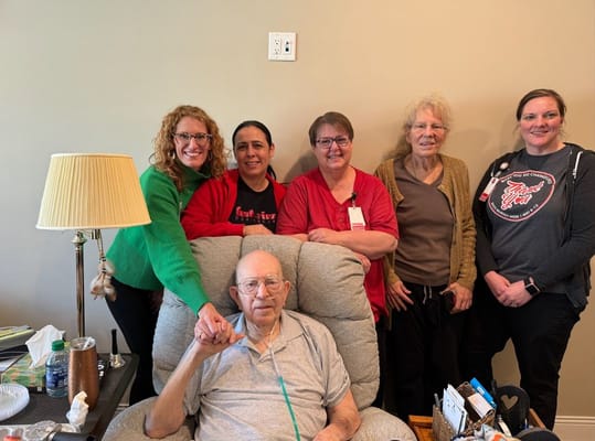 Staff members with a resident in a cozy common area