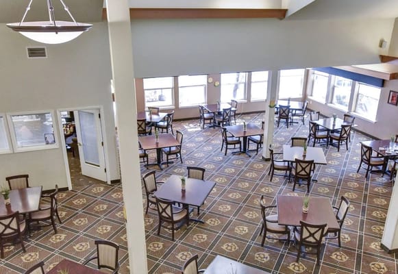 Dining area with tables and chairs in natural light