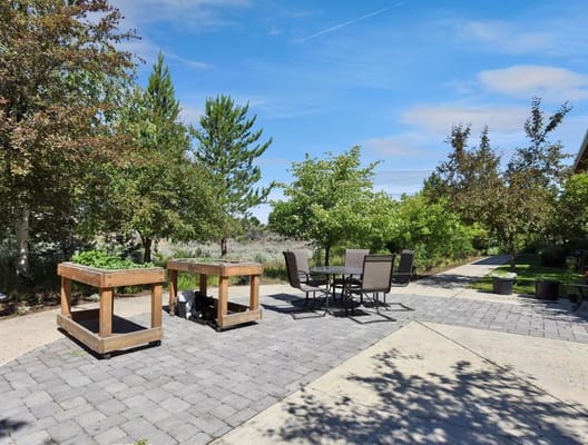Outdoor patio area with seating and greenery