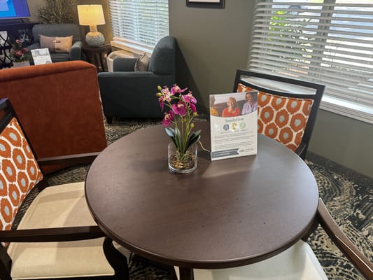 Cozy common area with seating and flower centerpiece