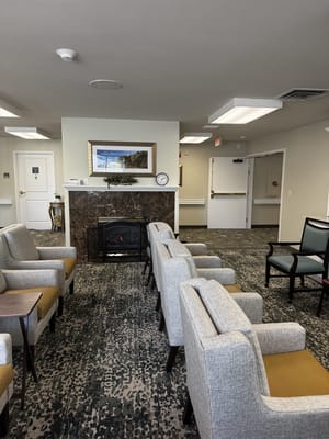 A cozy lounge area with seating and a fireplace