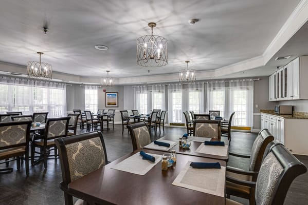 Dining area with tables and chairs set for residents