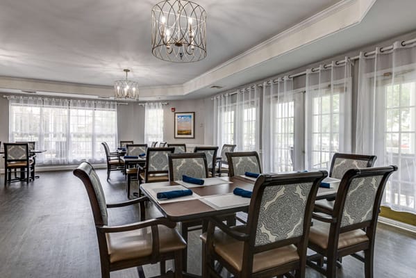 Dining room with tables and chairs set for meals