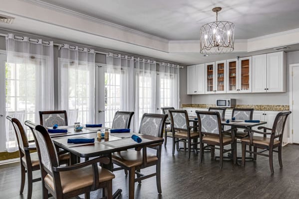 Bright dining area with tables and chairs set for a meal