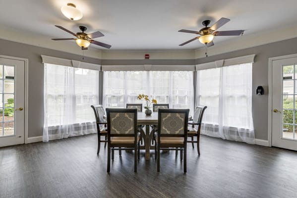 Bright and airy common area with large windows and seating