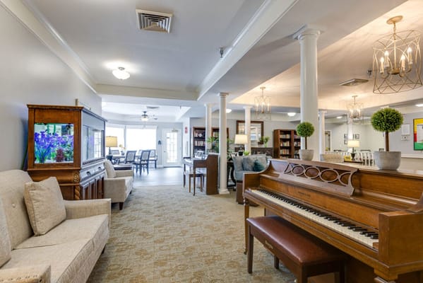Interior view of a welcoming common area with piano