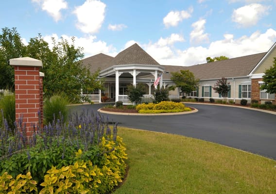 Front entrance of Charter Senior Living of Franklin with gardens