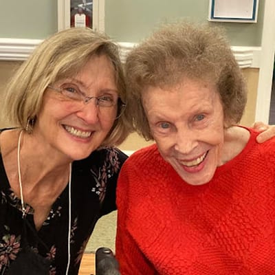 Staff member with a resident, both smiling