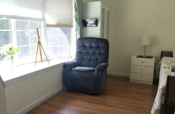 Cozy resident room with a chair and natural light
