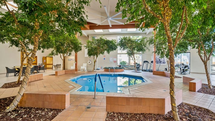 Indoor swimming pool surrounded by greenery