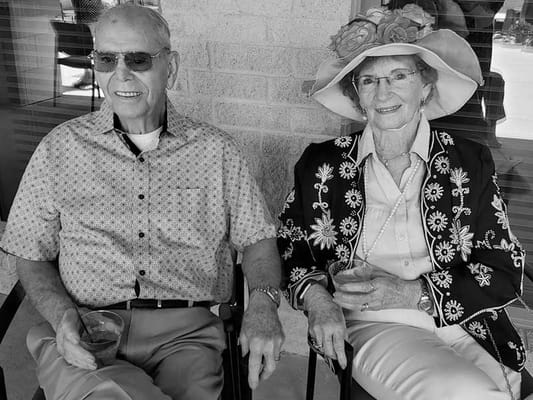Two residents enjoying drinks in a relaxed outdoor setting