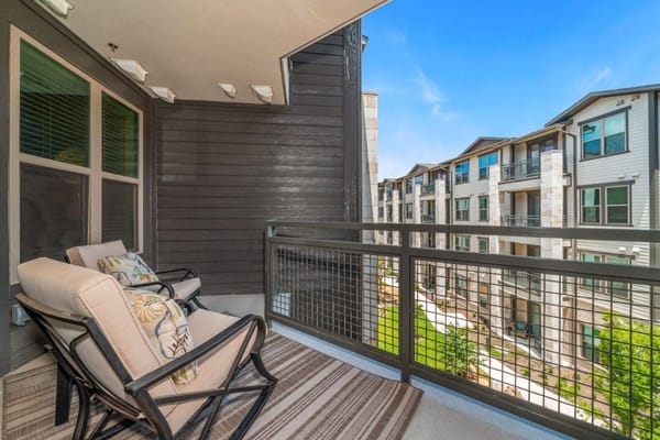 Balcony view with seating overlooking landscaped area