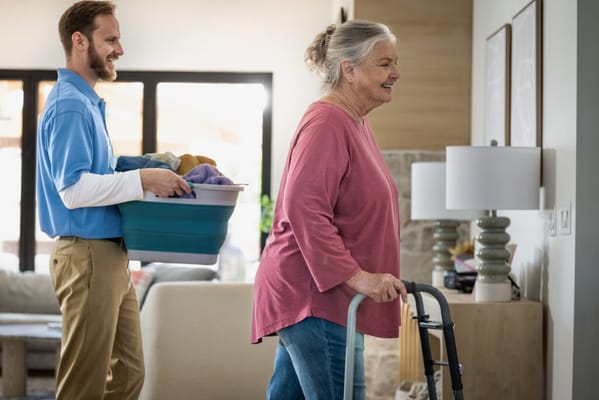 Staff assisting a resident in a common area