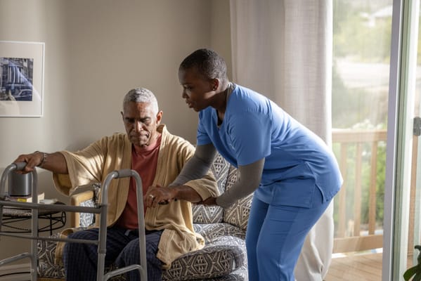 Caregiver assisting a resident in a cozy room