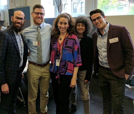 Staff members smiling together at an event
