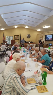 Residents enjoying bingo in a bright common area