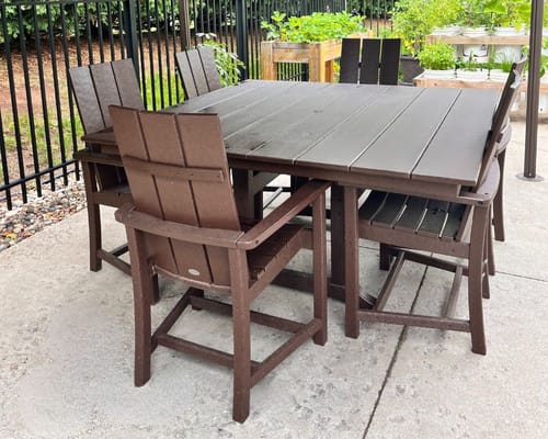 Outdoor dining table with chairs in a garden area