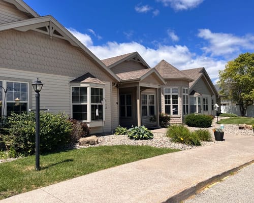 Exterior view of a senior living facility with landscaping