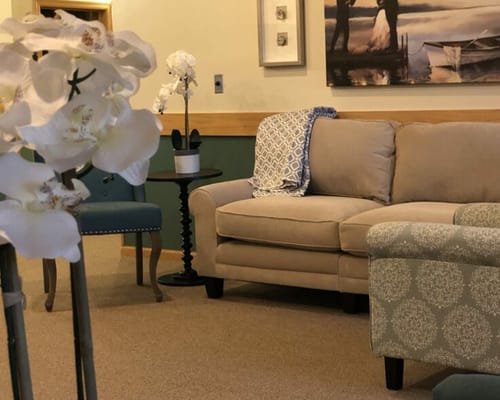 Cozy lounge area with a couch and flowers