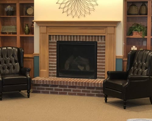 Cozy seating area with a fireplace and bookshelves