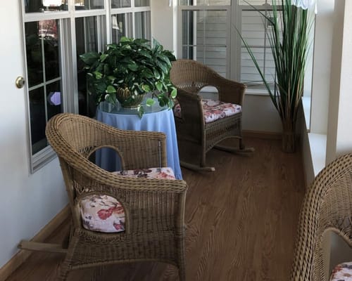 Welcoming interior seating area with wicker chairs and plants