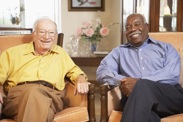 Two residents smiling in a common area
