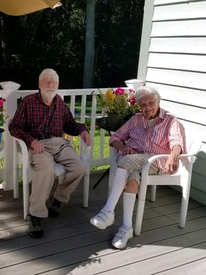 Two residents enjoying time on a porch