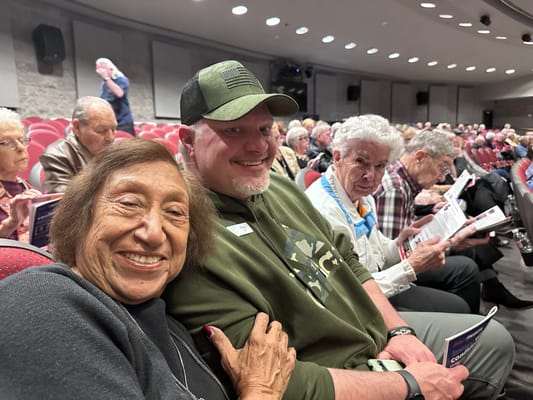 Residents enjoying a performance in an auditorium