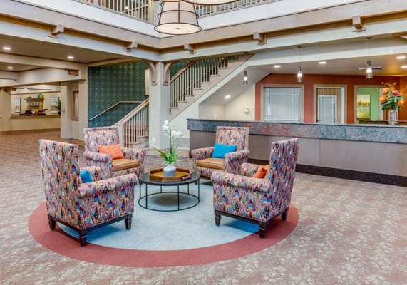 Bright common area with colorful chairs and decor