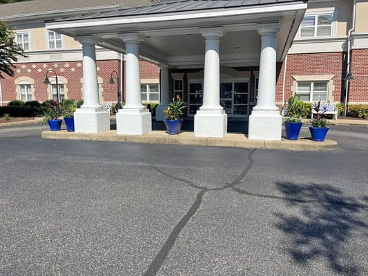 Entrance of a senior living facility with potted plants