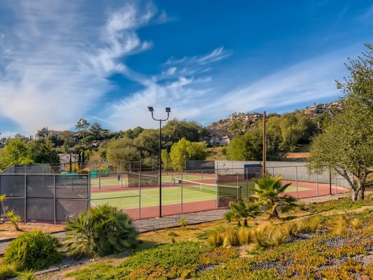 Outdoor tennis courts in a scenic setting