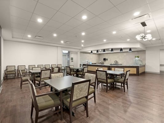 Bright dining room with tables and chairs set up