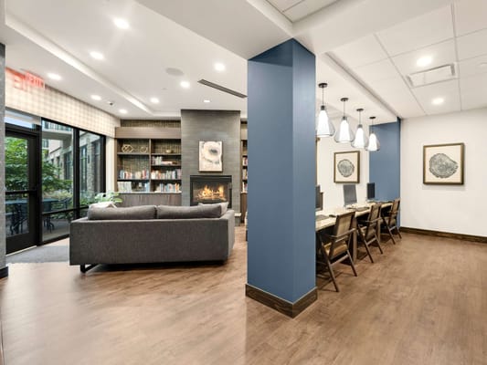 Cozy indoor common area with seating and a fireplace