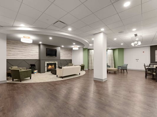A common area in the facility with seating and a fireplace