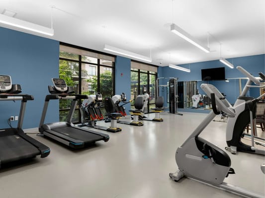An interior fitness room with exercise equipment