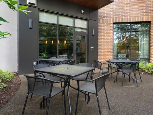Outdoor seating area with tables and chairs