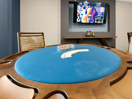 Card game set up on a blue table in a common area