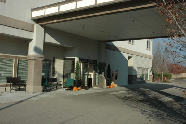 Entrance area with chairs, seasonal decorations, and double doors.