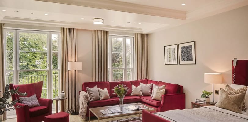 Cozy lounge area with red furniture and natural light