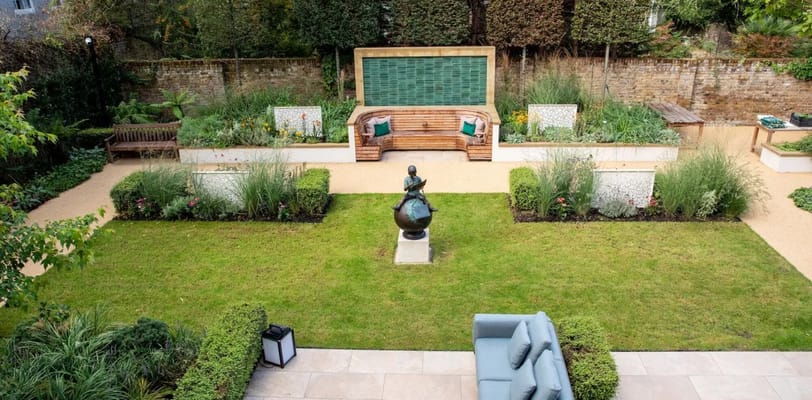 View of a serene garden space with seating and a statue