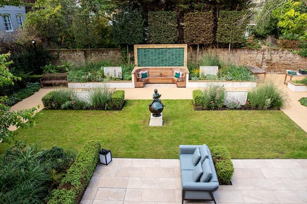 Well-maintained garden area with seating and sculpture