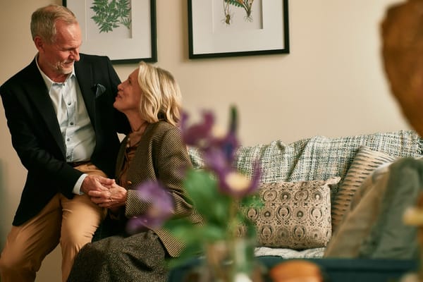 A couple enjoying a moment in a cozy common area