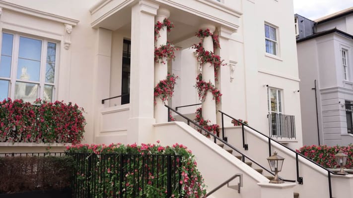 Exterior view of a facility entrance with floral decorations
