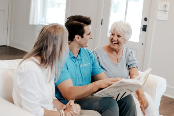 Caregiver and two residents enjoying a conversation