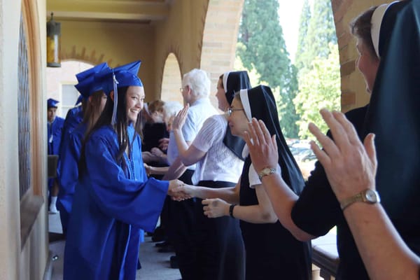 Students graduating and celebrating with staff members