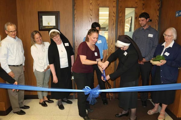 Ribbon-cutting ceremony with staff and residents