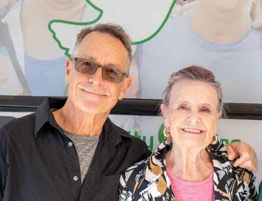 A smiling older woman and man posing together